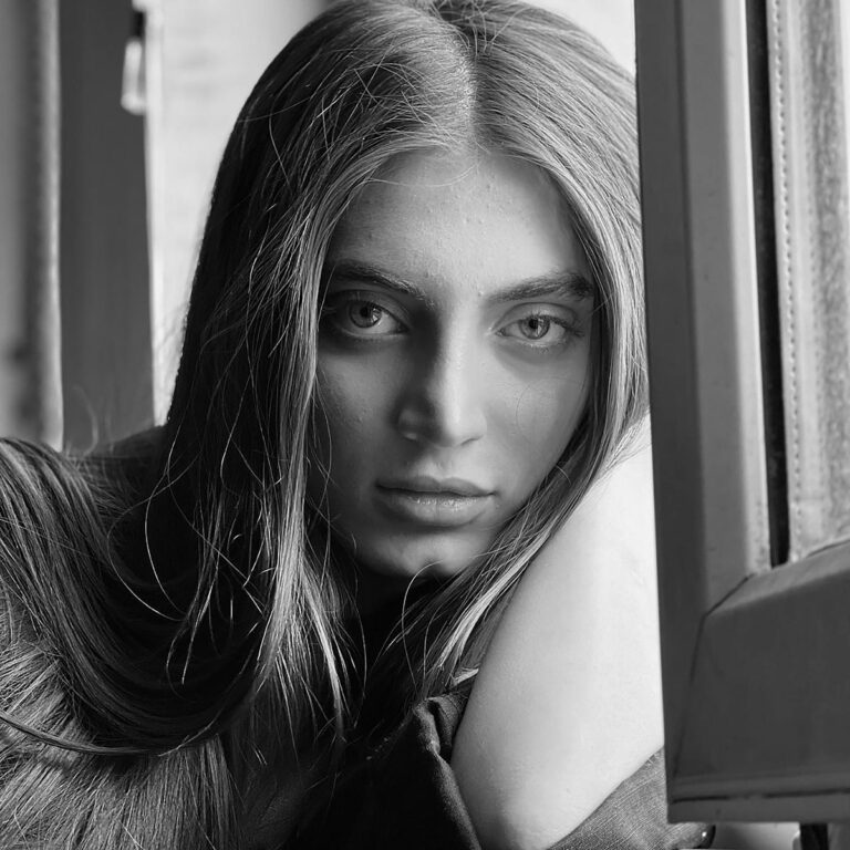 a black and white photo of a woman with long hair